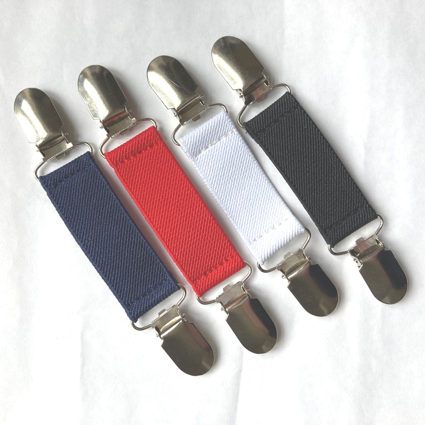 Close up of the 4 colour choices available for the Clip2Cuff: Navy, Red, White and Black
