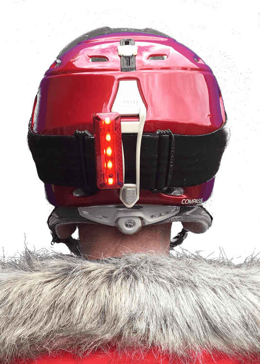 Close up of trixski LED Ski Helmet Light in use on the back of a ski helmet
