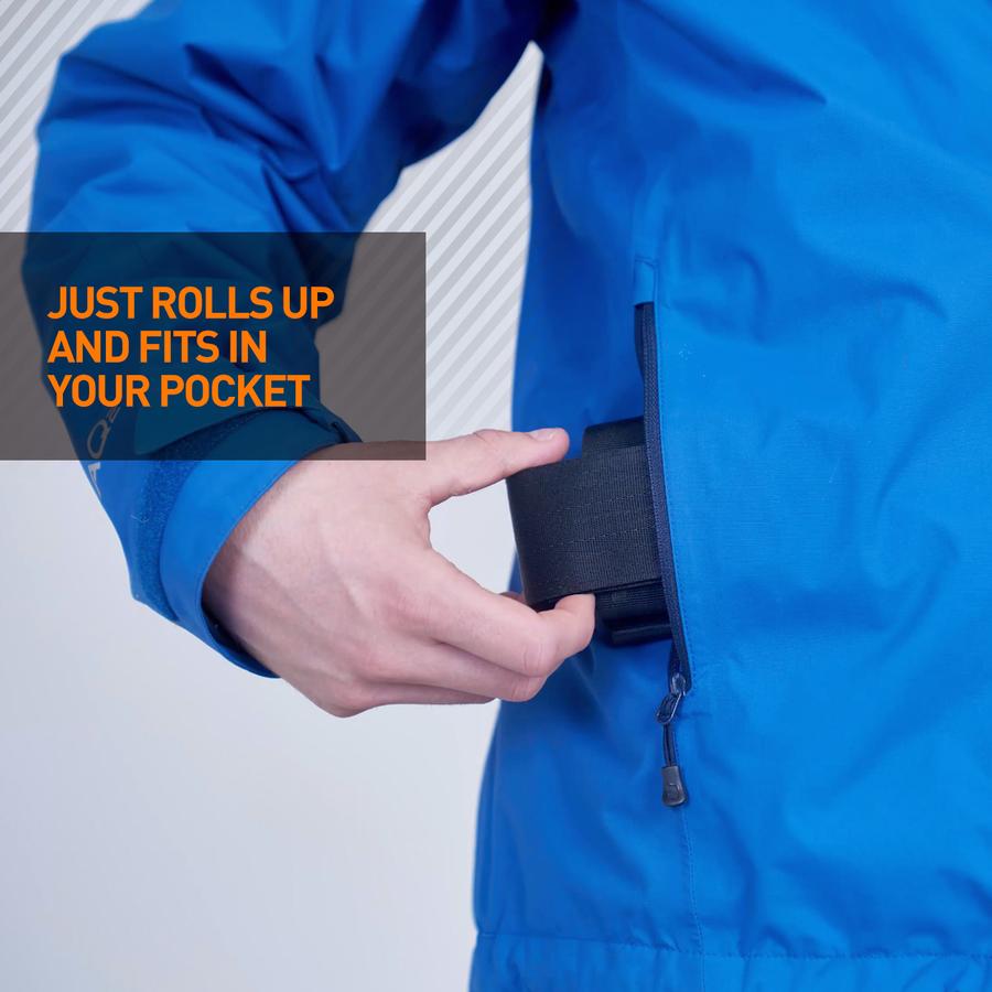 Rolled up black trixski Ski Carrier being inserted into a ski jacket pocket