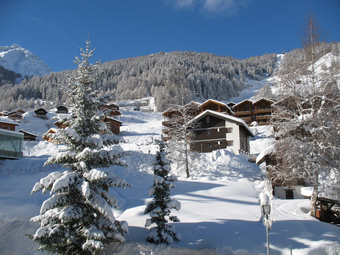 Snow scene of Swiss chalets up the hillside in Girmentz-Zinal