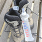 Pair of walking boots with a trixski bottle on a wooden seat