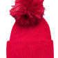 Bright red knitted hat with deep welt and bright red faux fur pom pom