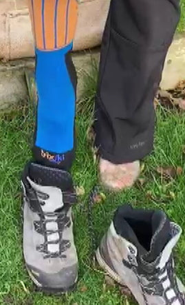 Hiker wearing trixski Merino blend socks putting foot into walking boot