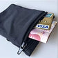 Black wrist wallet with money and a Visa card inserted into zip pocket