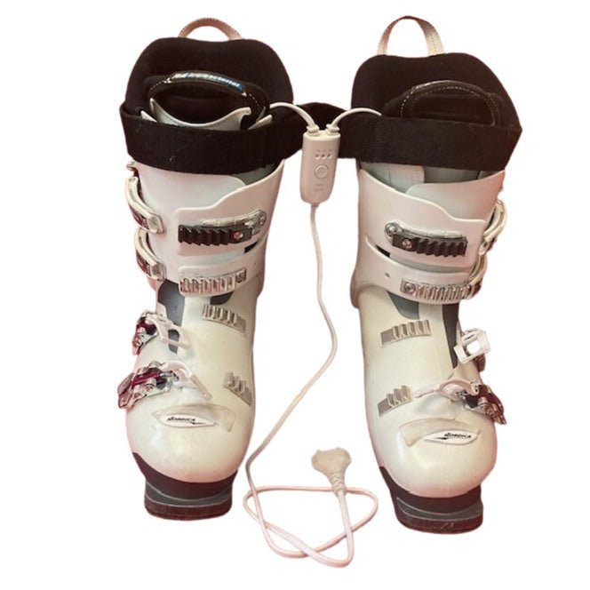 Boot driers being used: showing leads going down into each ski boot, timer and cable with EU plug