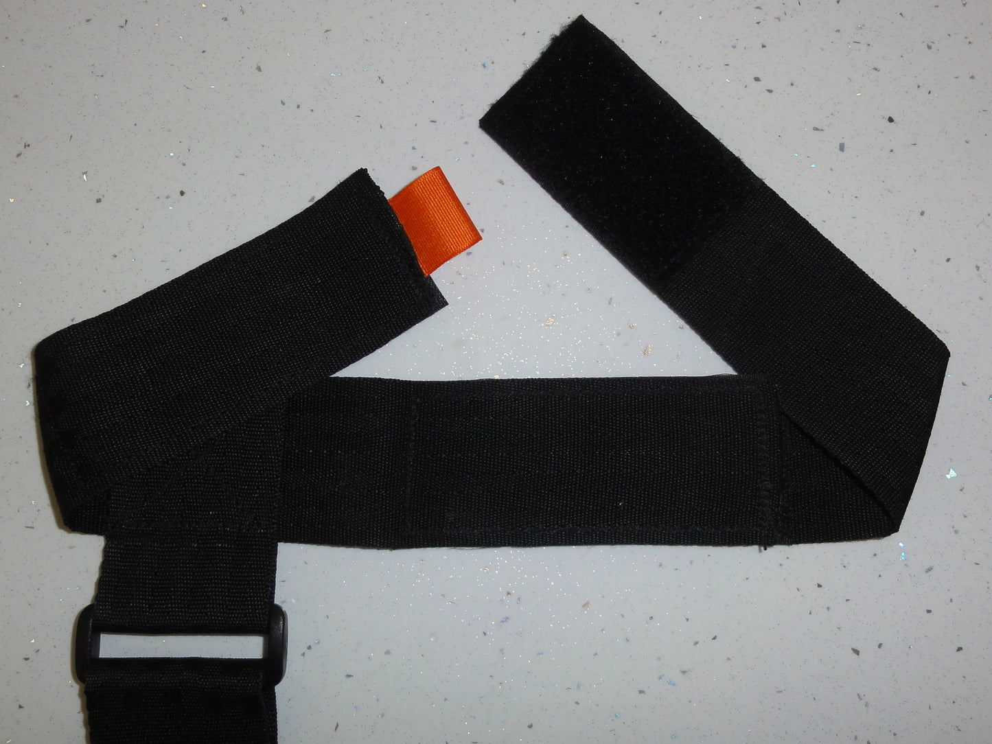 Black option extension kit attached to the velcro at one end of a trixski ski carrier