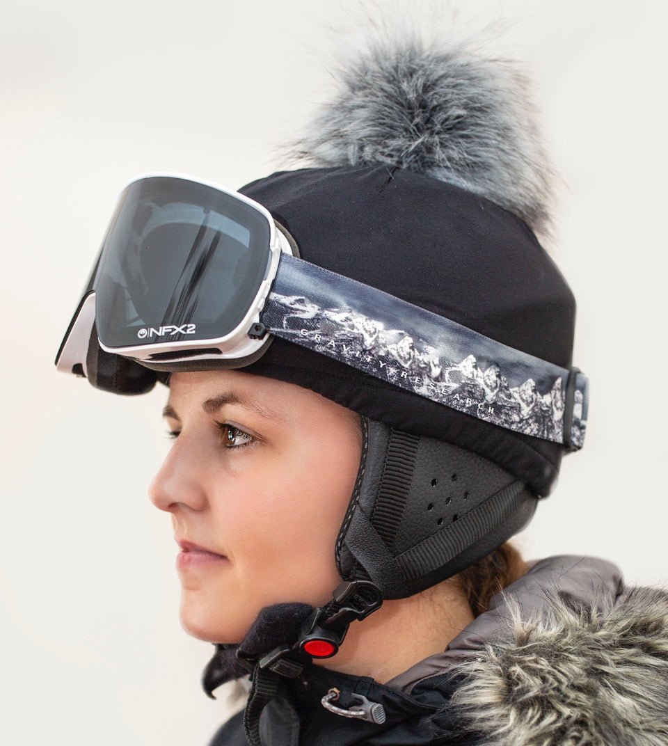 Side view of trixski Ski Helmet Cover with grey Faux Fur Pom Pom