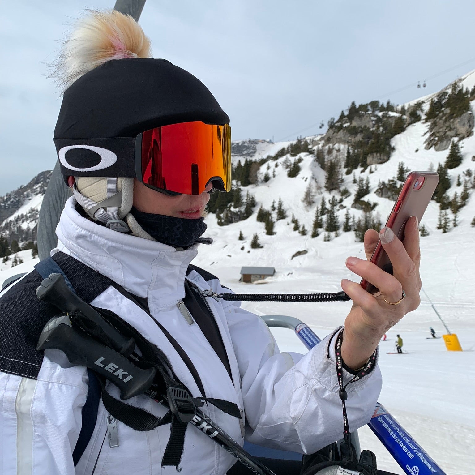 Snowy mountain location showing side view of trixski PhoneSafe in use on a chair lift