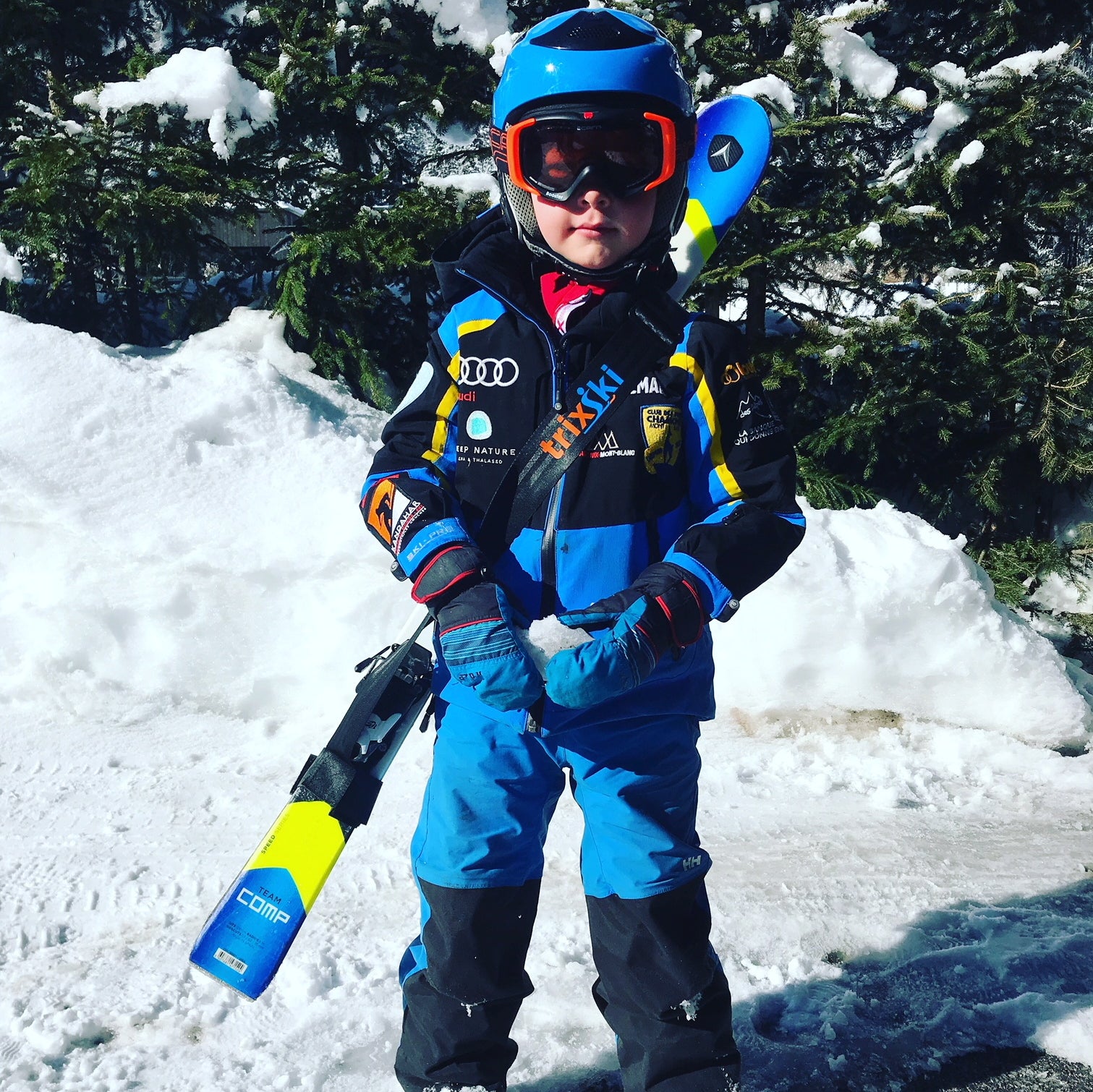 Child of 3-4 years with trixski Ski Carrier diagonally across his body to carry his skis
